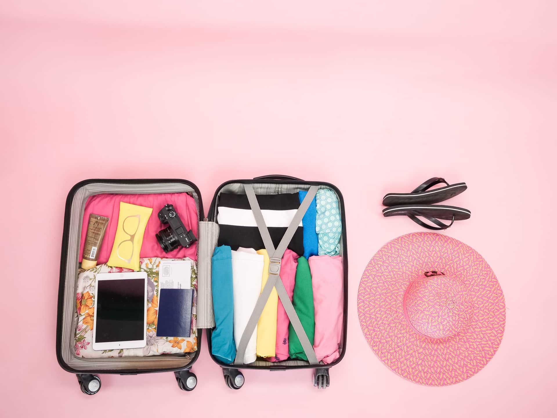 A neatly packed open bag with clothes rolled and sorted