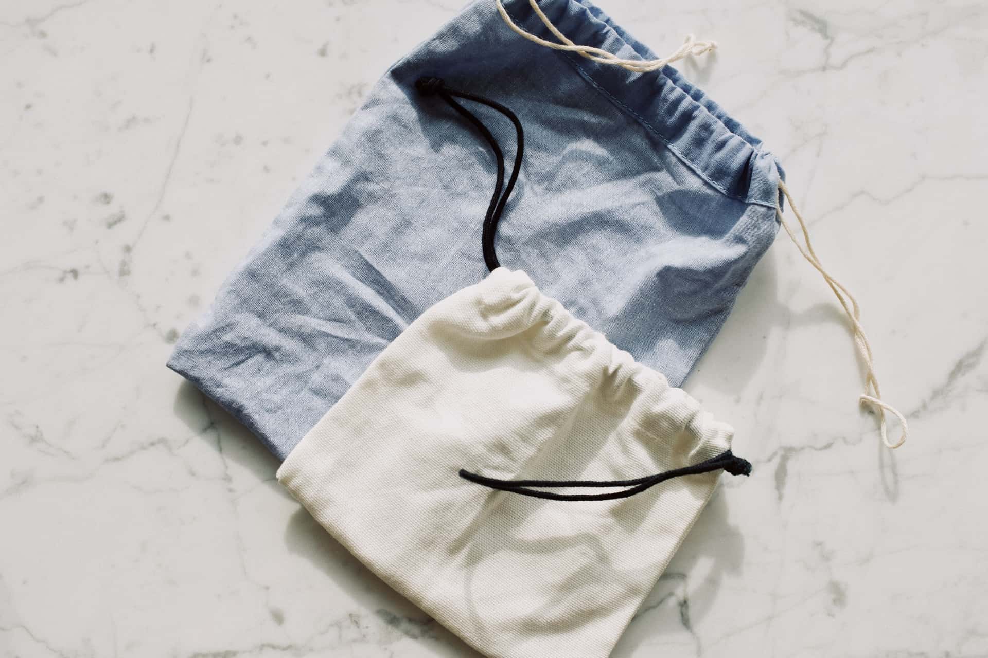 Travel pouches and drawstring bags laid out flat