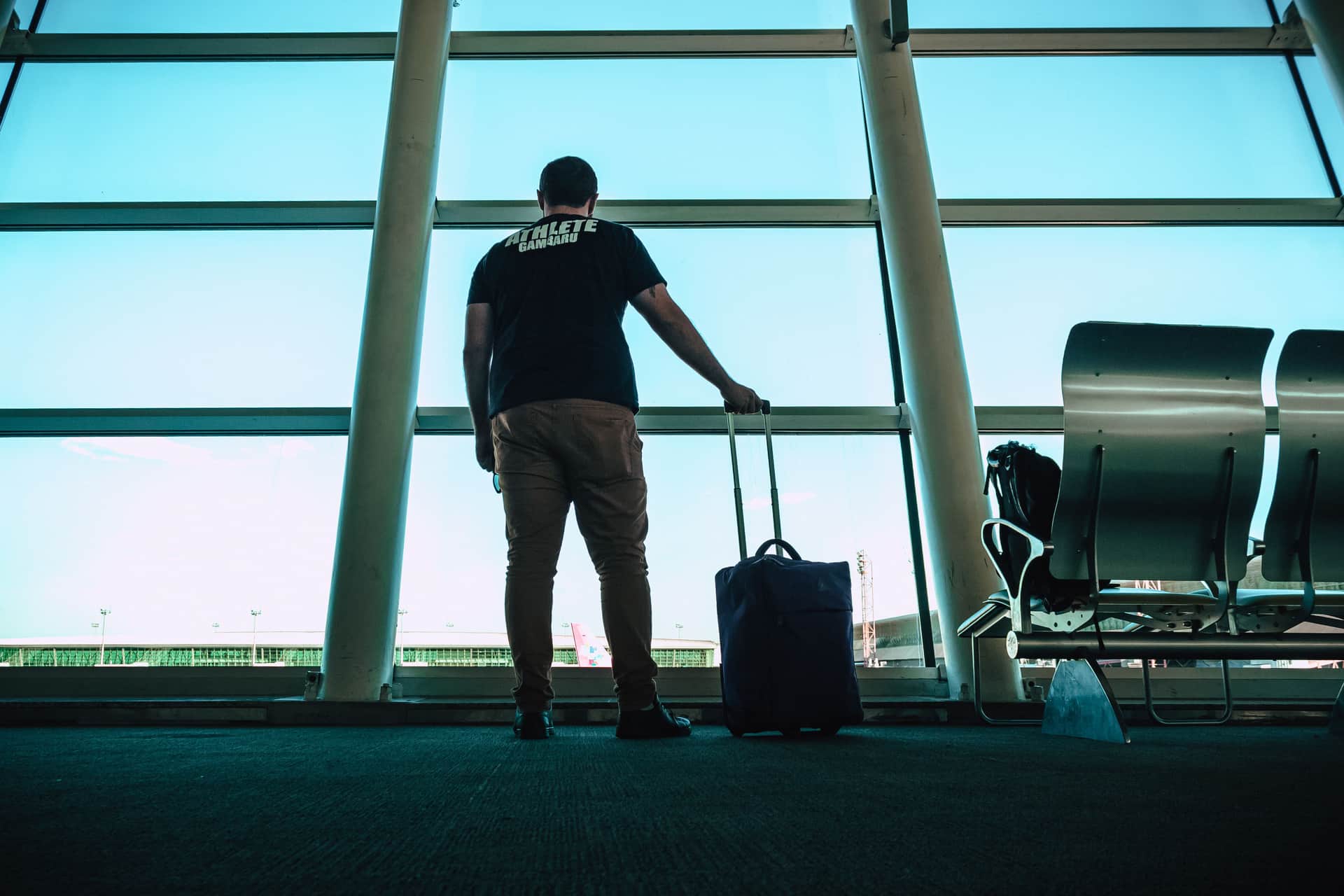 A traveler carrying a carry-on bag at the airport