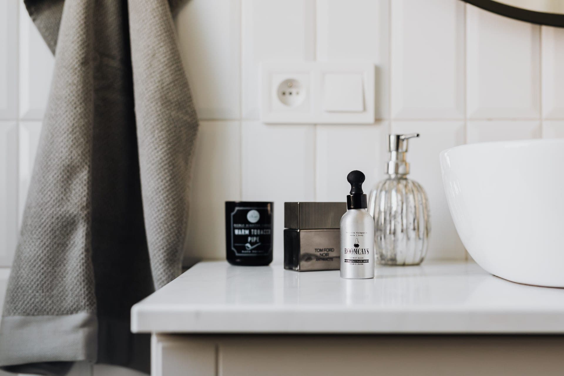 Travel toiletries and a wash bag on a bathroom counter