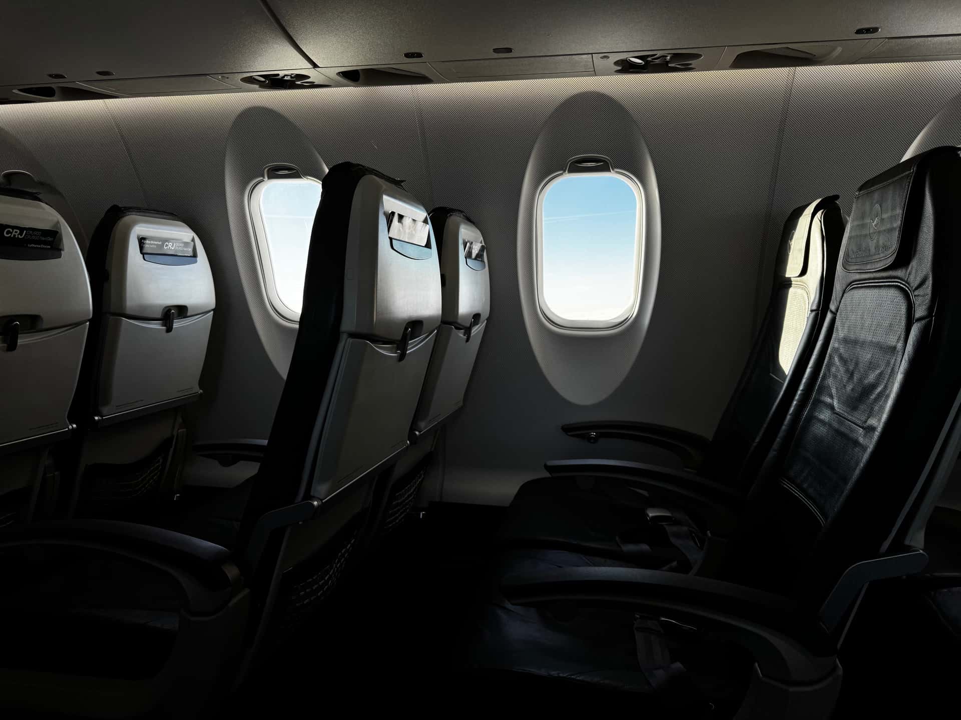The cabin interior of an airplane with a row of seats